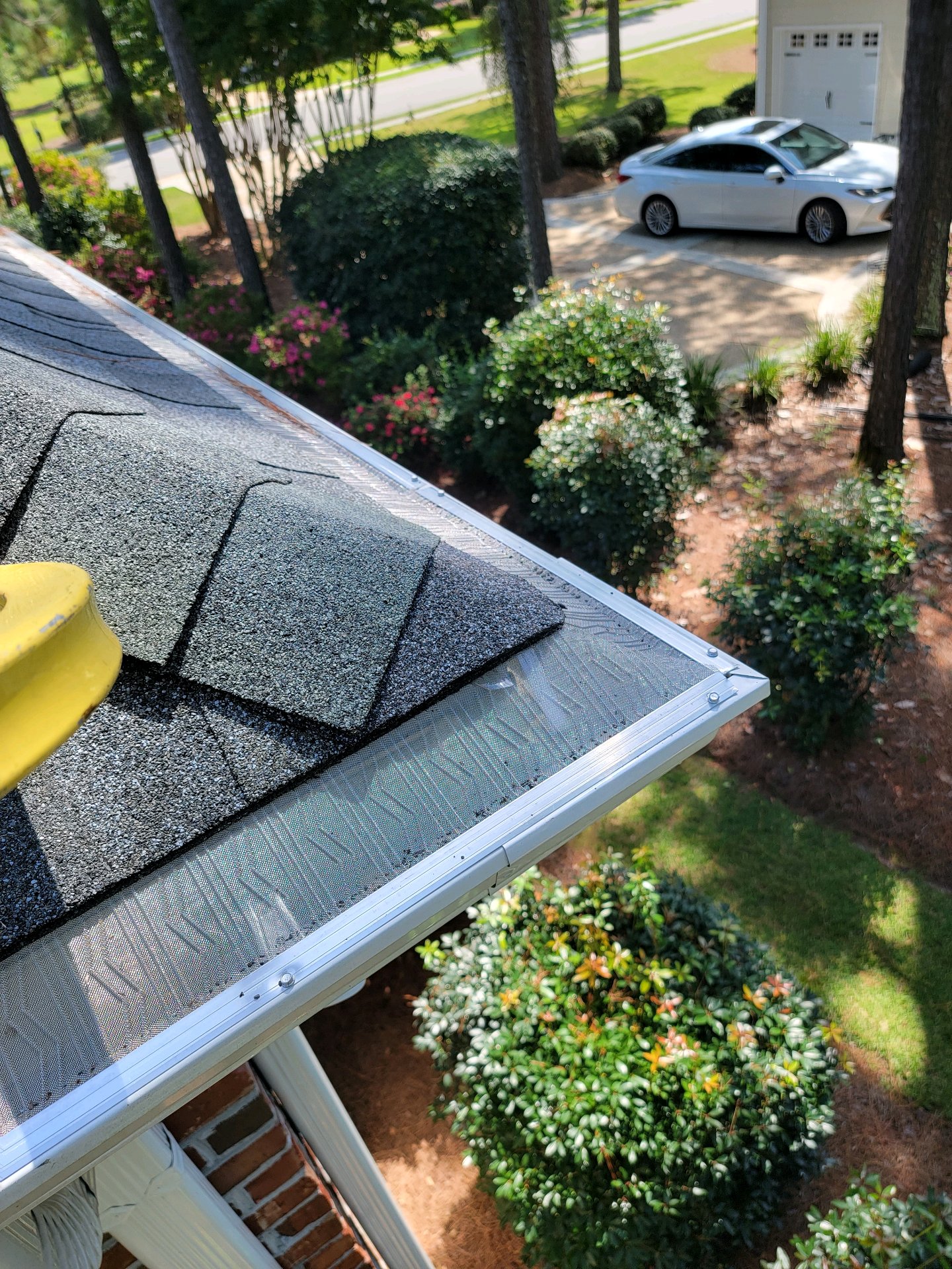 Close detail of micro-mesh gutter guard installation at a residential gutter corner