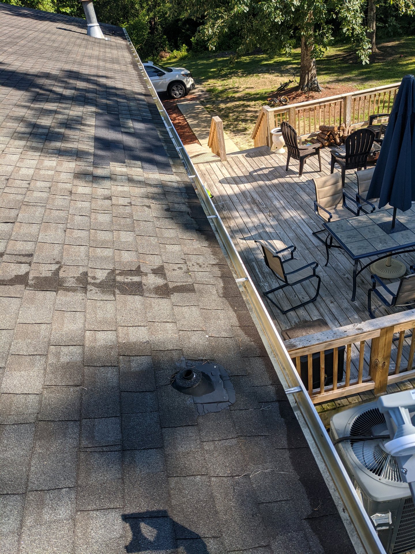 Finished residential gutter guard installation viewed from a roofline